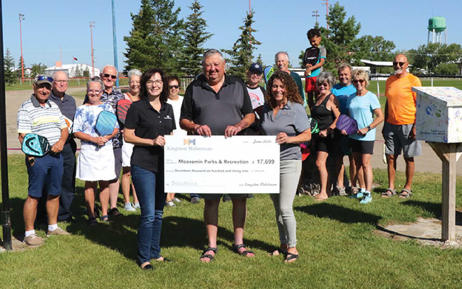 Moosomin Mayor Larry Tomlinson accepting the donation for new pickleball courts from Kingston Midstream’s Dena Bachorcik, left, and Tammy Davies, right.